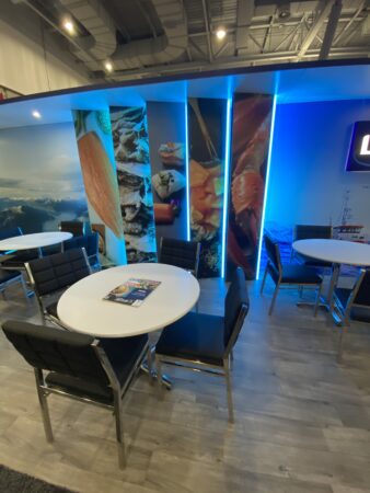 Blue booth with led lit edges and white table